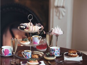 A tiered dessert stand with various pastries and a glass of champagne. - Oaklands Hall Hotel Grimsby (Grimsby)