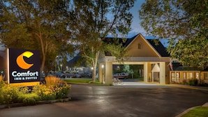 A Comfort Inn & Suites with a well-lit entrance, a covered walkway, and a parking area.