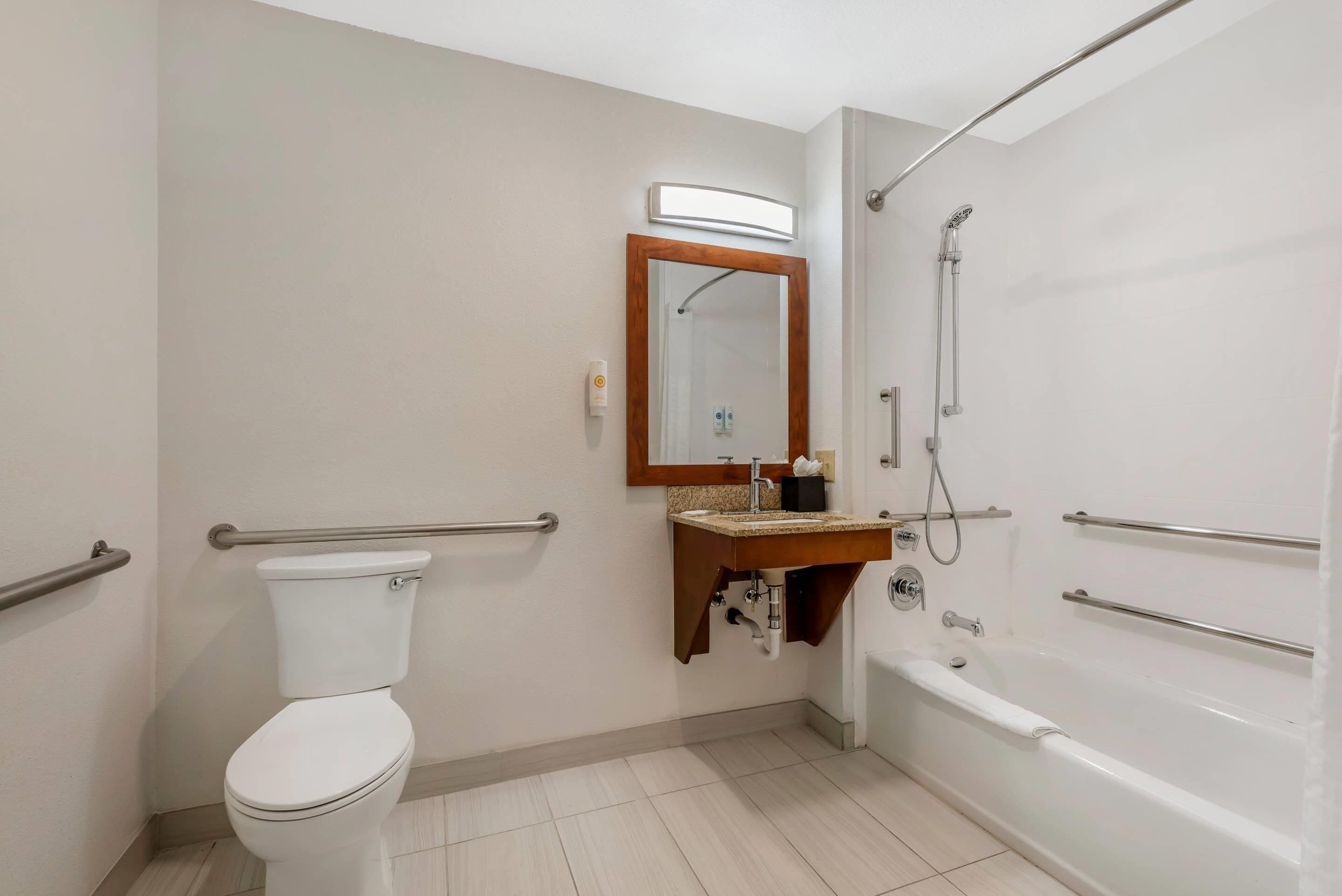 A bathroom with a toilet, sink, and bathtub.