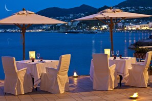 Enjoy a romantic dinner with a scenic view of the water and a serene atmosphere.