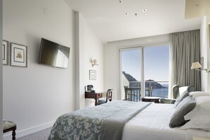 Enjoy a restful stay in this stylish room with a large bed, flat-screen TV, and breathtaking sea views.