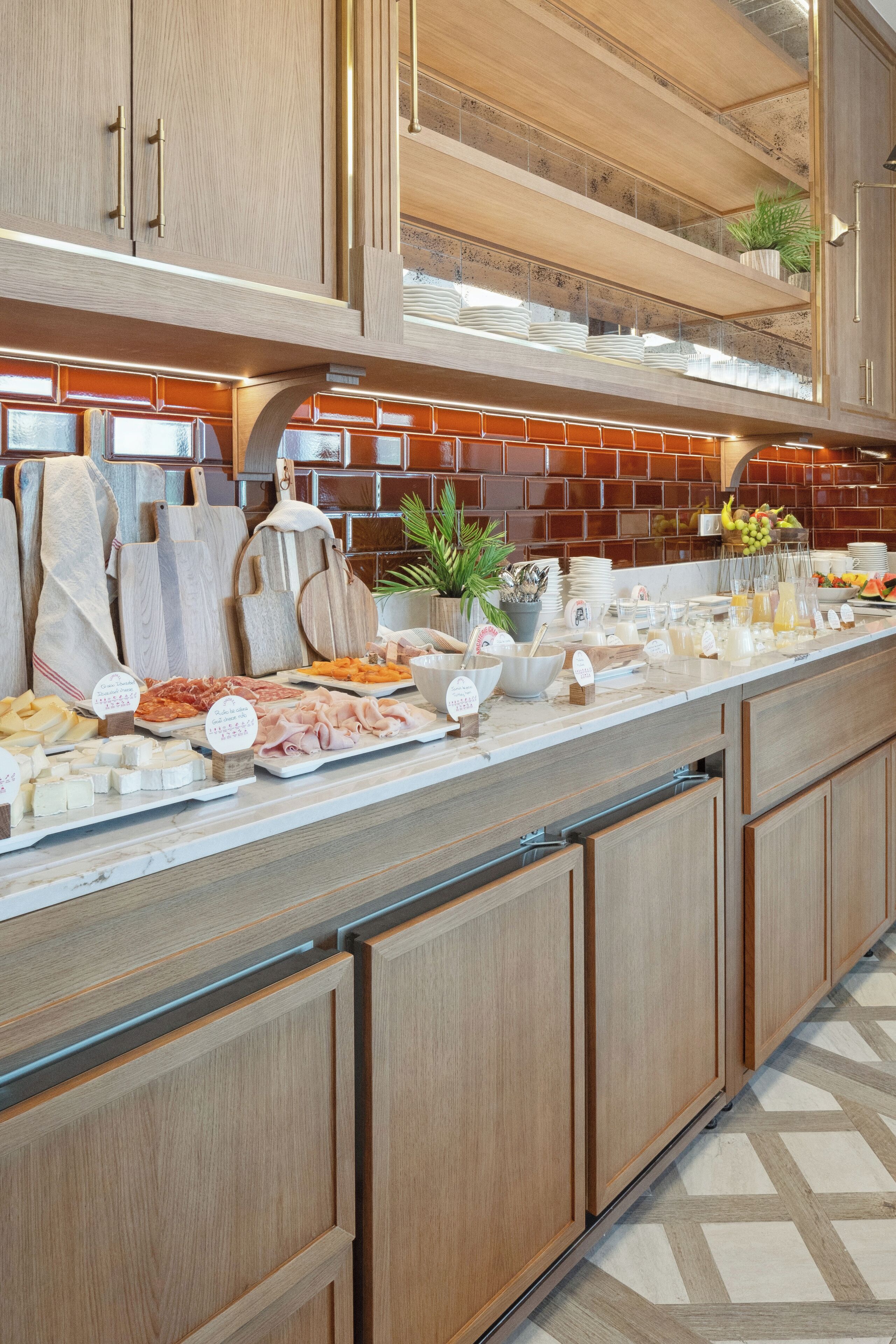 A kitchen with wooden cabinets, a marble countertop, and a tiled backsplash.