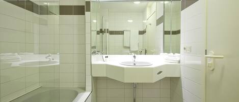 A modern bathroom with a glass shower enclosure, a white sink, and a large mirror.