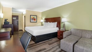 A hotel room with a bed, a desk, a chair, a sofa, and a lamp. - Best Western Charlotte-Gastonia (Gastonia)