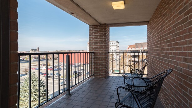 A balcony with a view of a parking lot and buildings. - Courtyard by Marriott Springfield Downtown (Springfield)