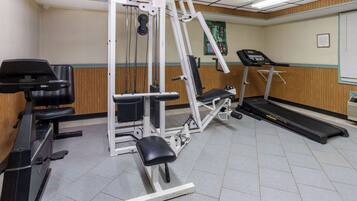 A gym with cardio equipment, weight machines, and a treadmill.