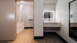 A modern bathroom with a shower, a sink, and a mirror. - Red Roof Inn Chattanooga - Hamilton Place (Chattanooga)