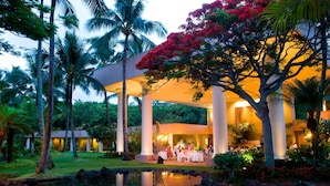A resort with a covered outdoor dining area, palm trees, and a pond. - The Royal Sonesta Kaua'i Resort Lihue (Lihue)