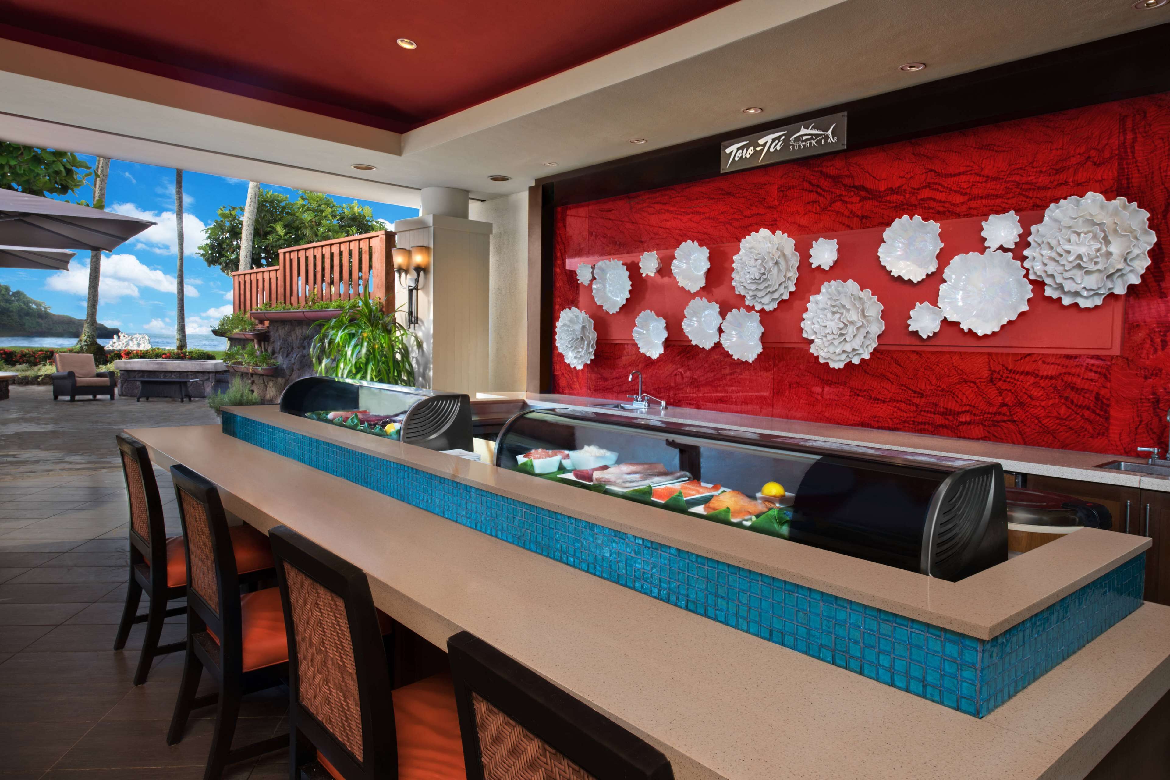 A buffet area with a long counter, seating, and decorative wall panels.