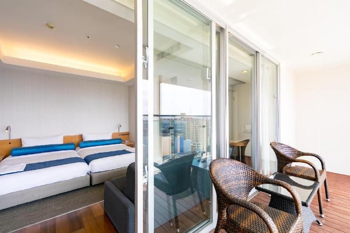 Premium bedding, desk, laptop workspace, blackout drapes