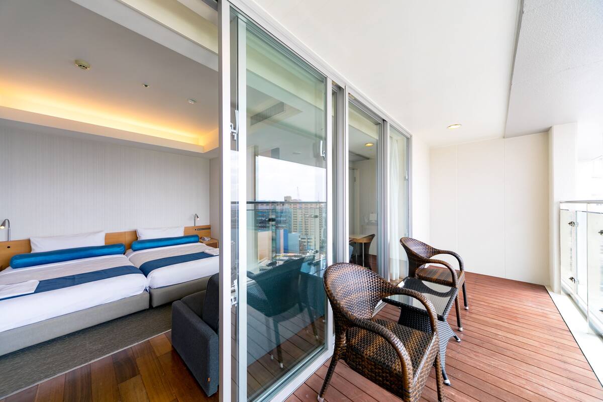 Premium bedding, desk, laptop workspace, blackout drapes
