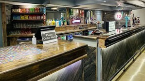 A bar area with a 'Please Order Here' sign, shelves with snacks, and a counter with a digital display. - Fairways Lodge & Leisure Club (Manchester)