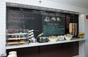 A menu board at Jhouse Coffee Bar with various food and drink options listed. - J House Greenwich (Riverside)