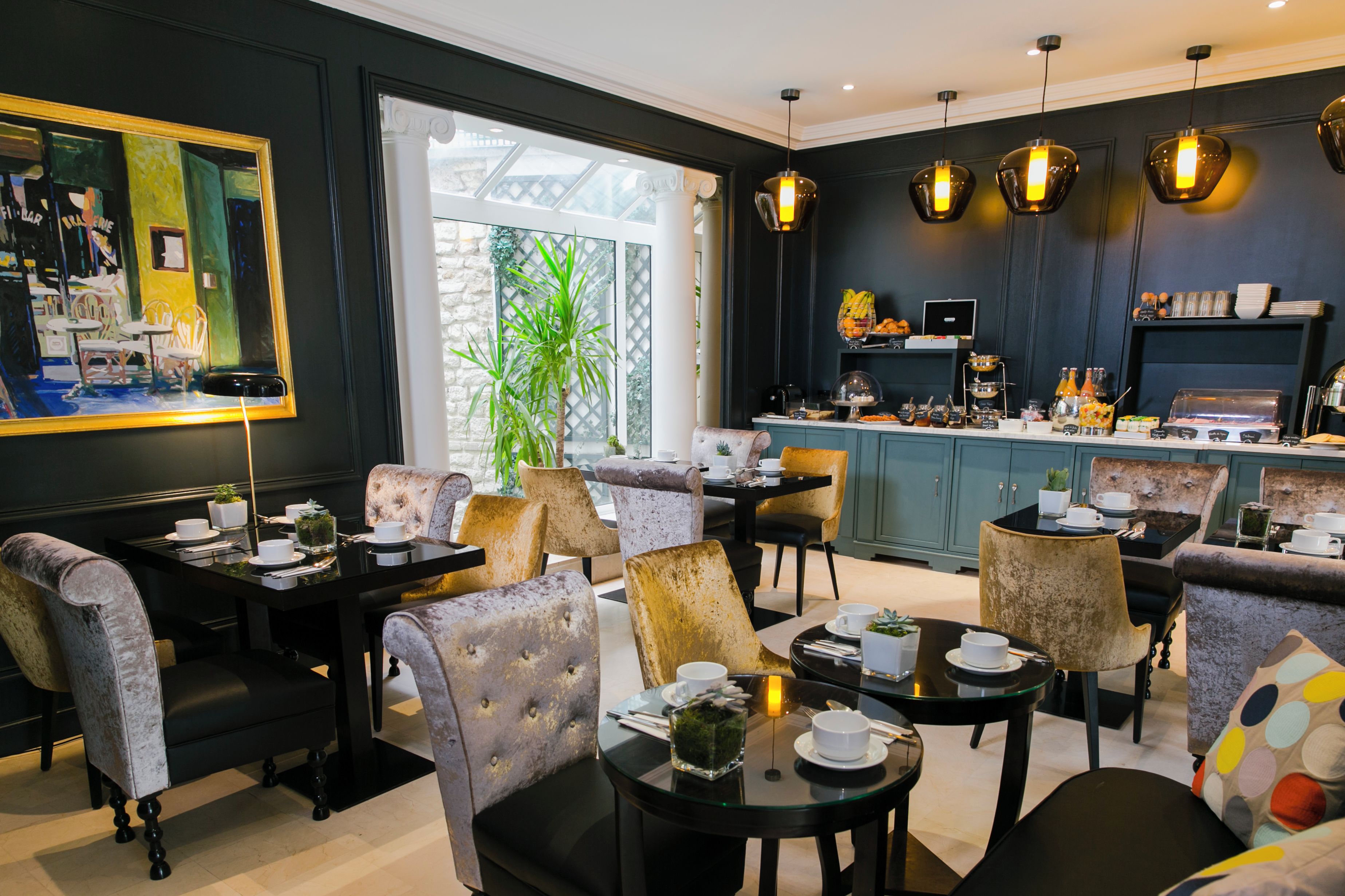 A modern dining area with a bar, comfortable seating, and a view of the outdoors.