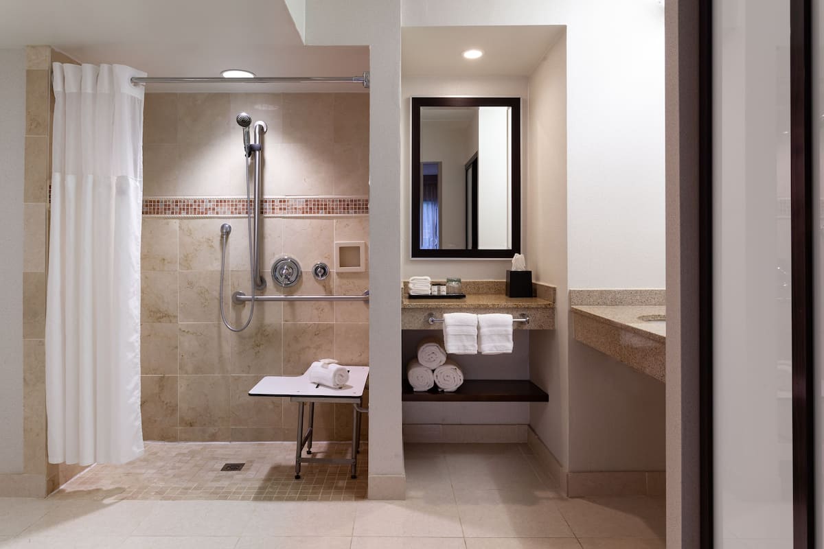 suite, 1 king bed with sofa bed (mobility/hearing access, roll-in shwr) | bathroom | combined shower/bathtub, designer toiletries, hair dryer, towels