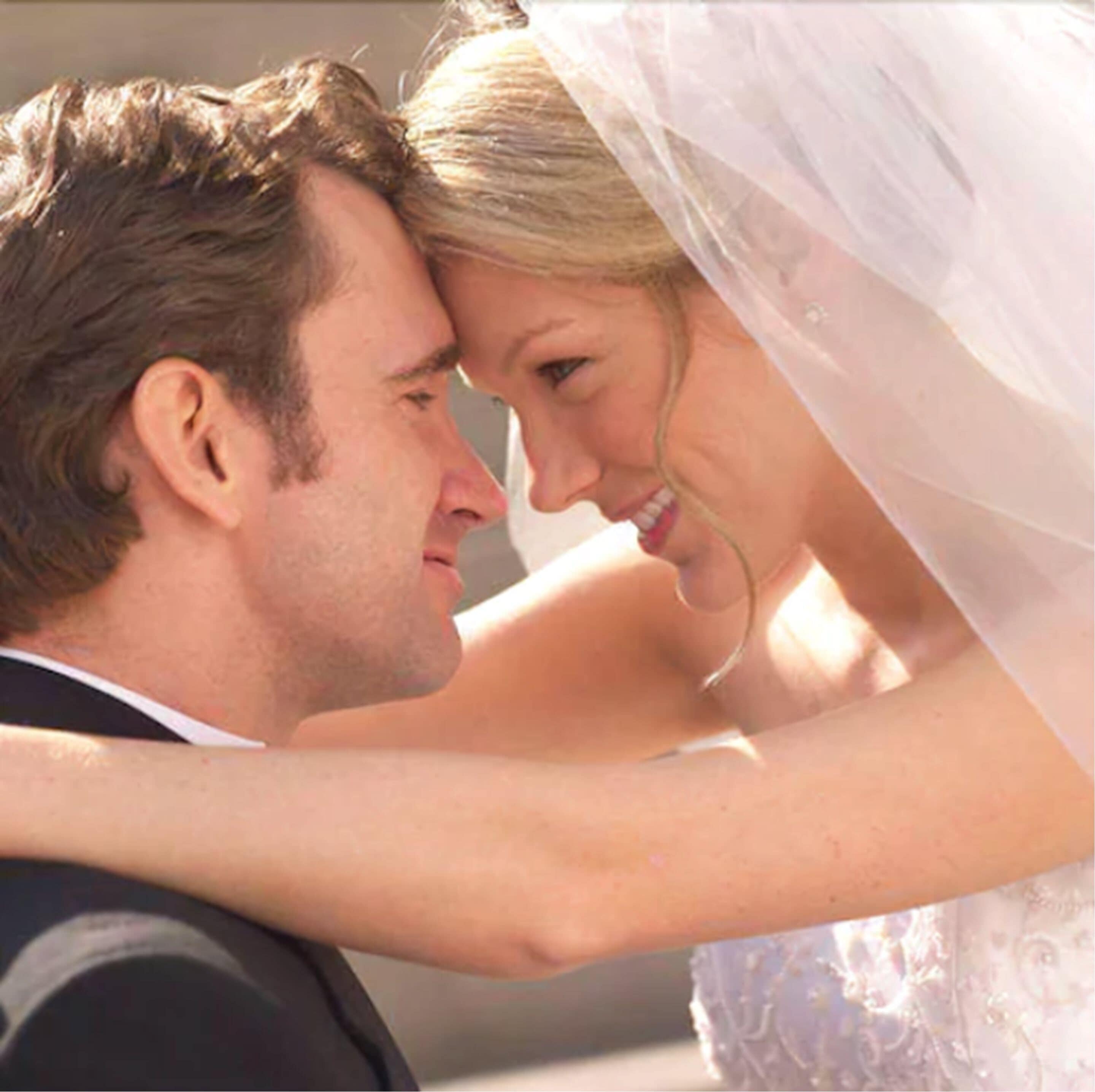 A wedding scene with a bride and groom embracing.