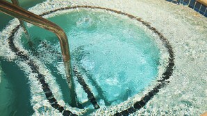 A swimming pool with a visible water filtration system and a tiled edge.