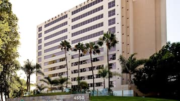 Experience Embassy Suites' welcoming atmosphere amidst lush greenery and a well-manicured lawn.