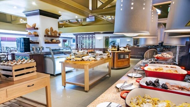Un buffet proposant une variété de plats et d’ustensiles de service.