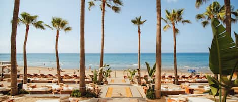 On the beach, sun loungers, beach umbrellas, beach towels