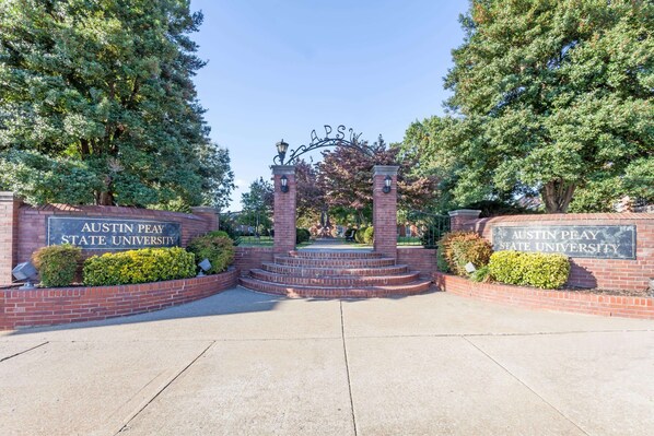 The entrance to Austin Peay State University with a brick archway and a sign above it.