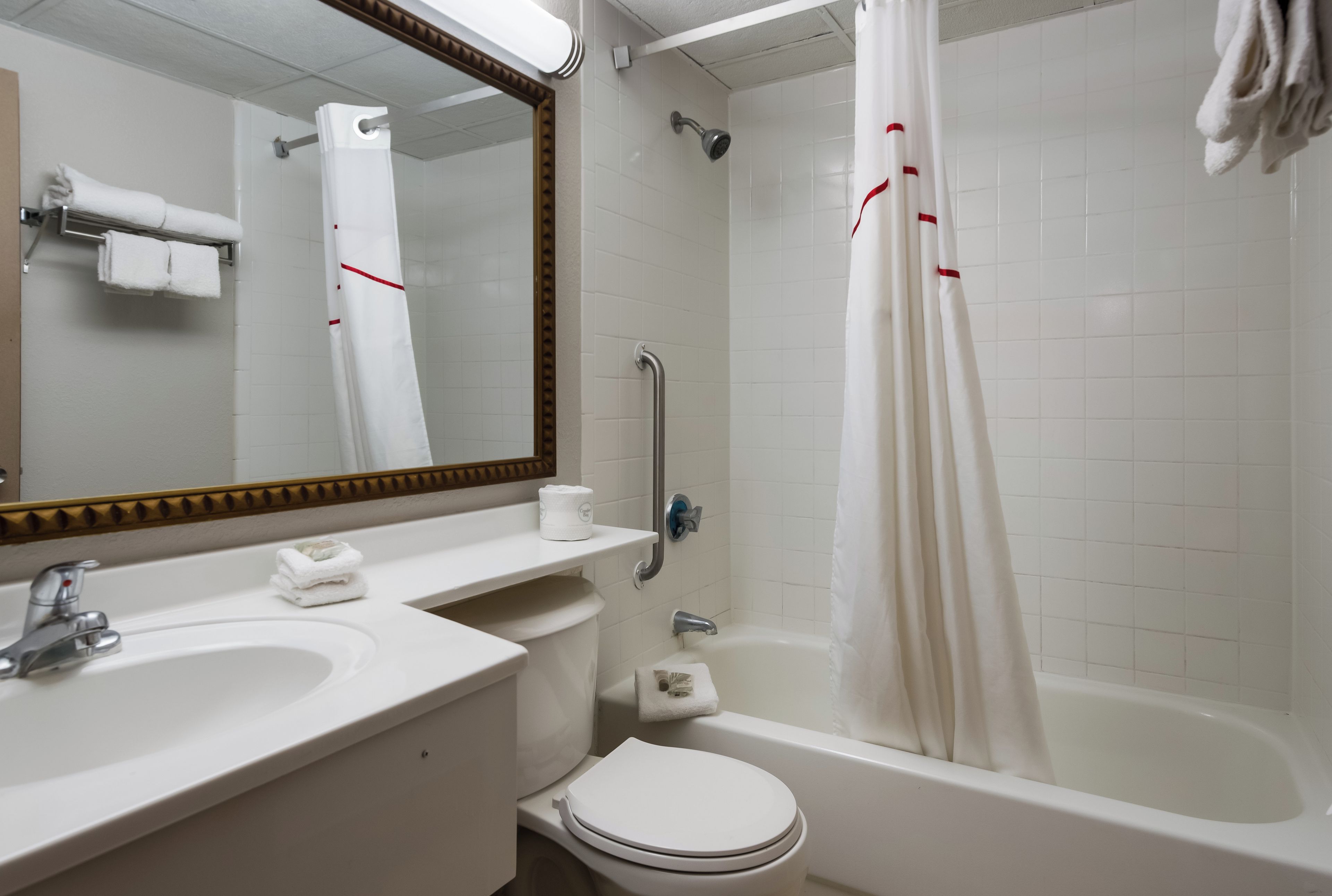 A bathroom with a toilet, sink, and bathtub.