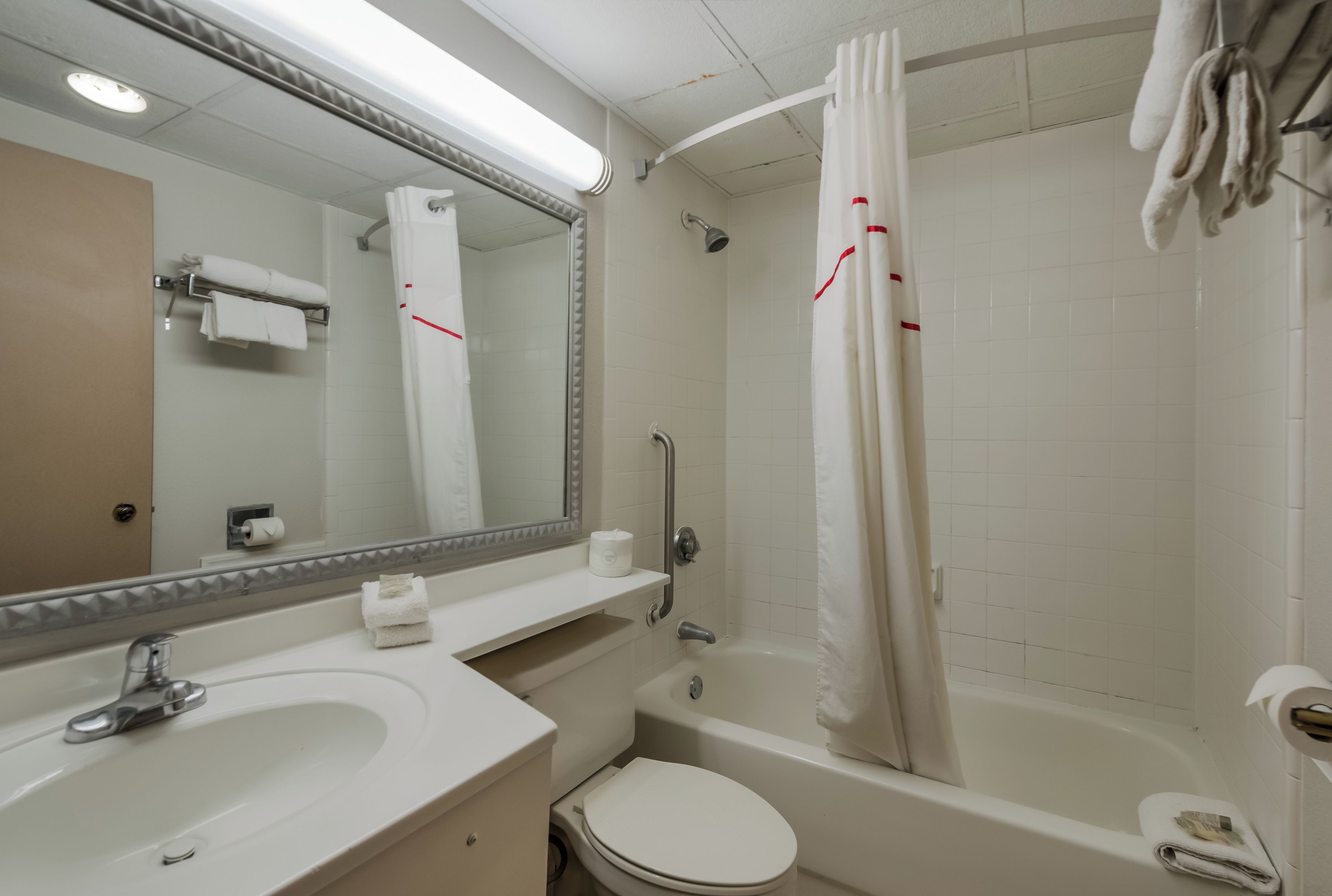 A bathroom with a sink, toilet, and bathtub.