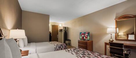 A hotel room with two beds, a desk, a chair, a TV, and a mirror.