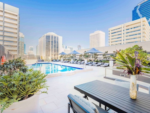 Outdoor pool, open 6:00 AM to 9:00 PM, pool umbrellas, pool loungers