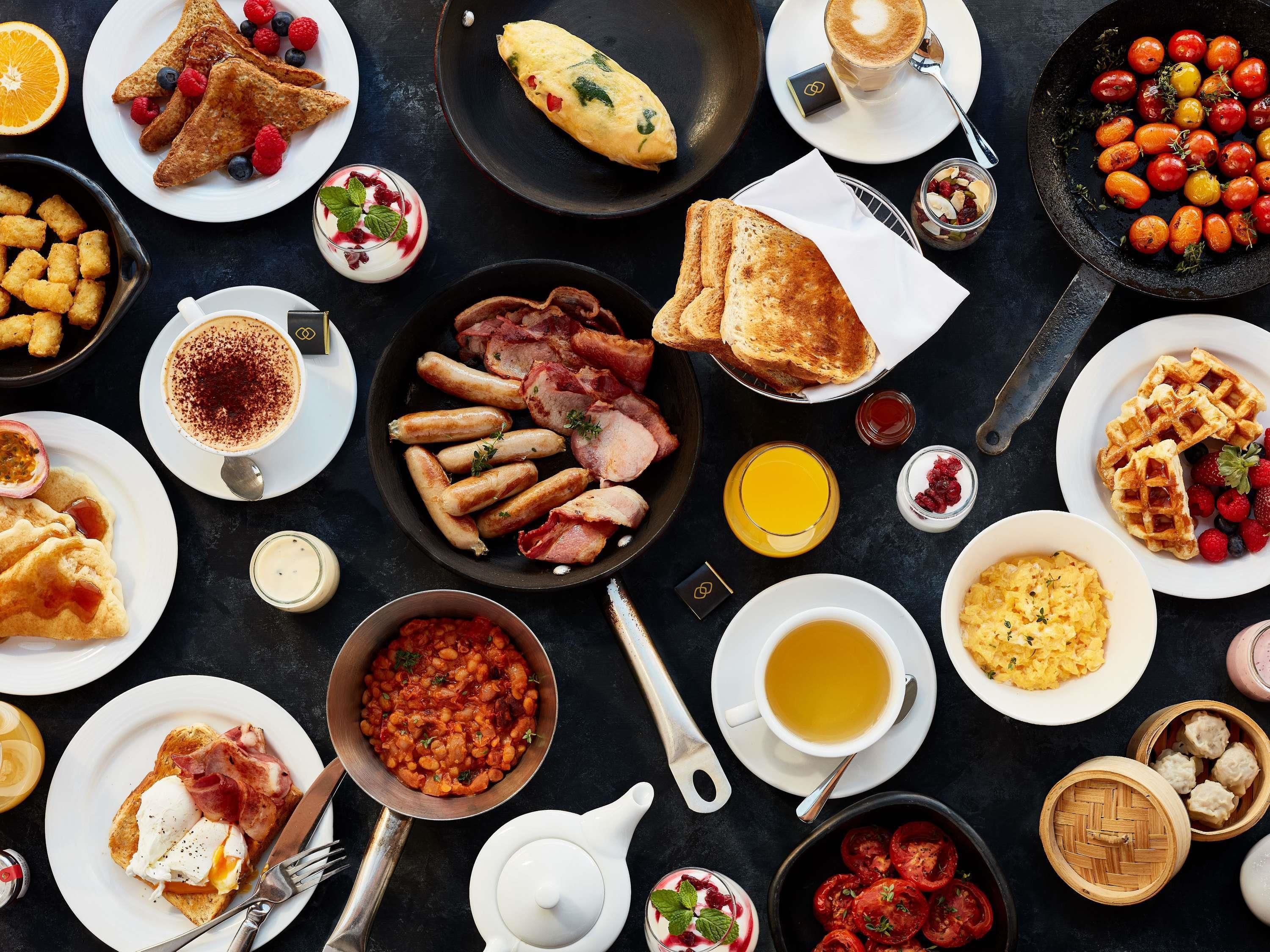 A breakfast spread with various dishes and drinks.