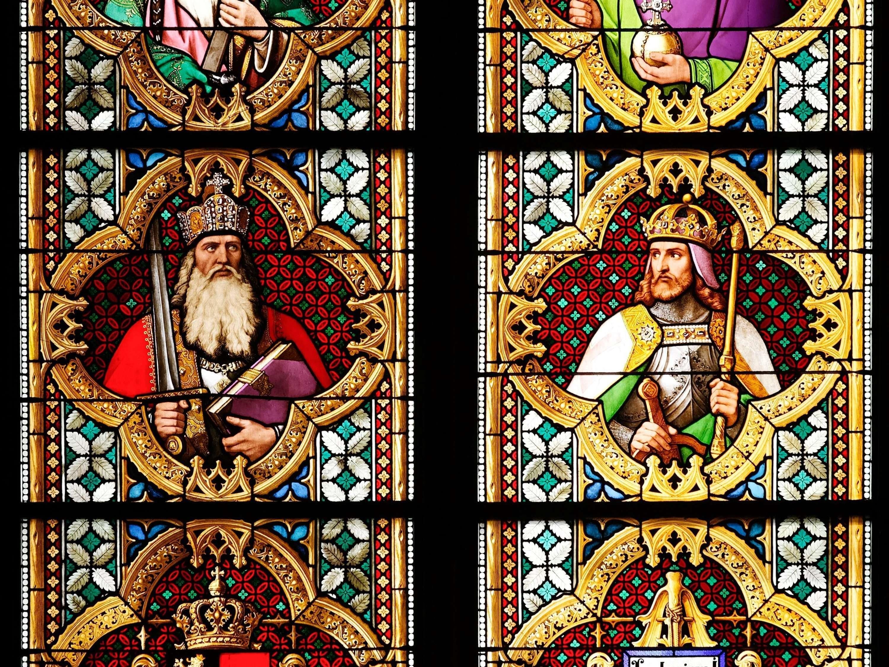 A stained glass window with intricate designs and figures.
