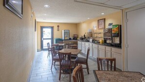 A hotel lobby with a reception desk, seating area, and a kitchenette. - Days Inn by Wyndham Pauls Valley (Pauls Valley)