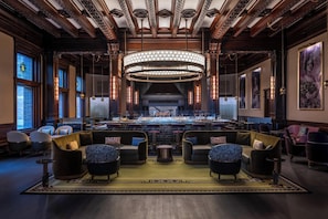 A spacious lobby with a grand chandelier, comfortable seating, and a fireplace.