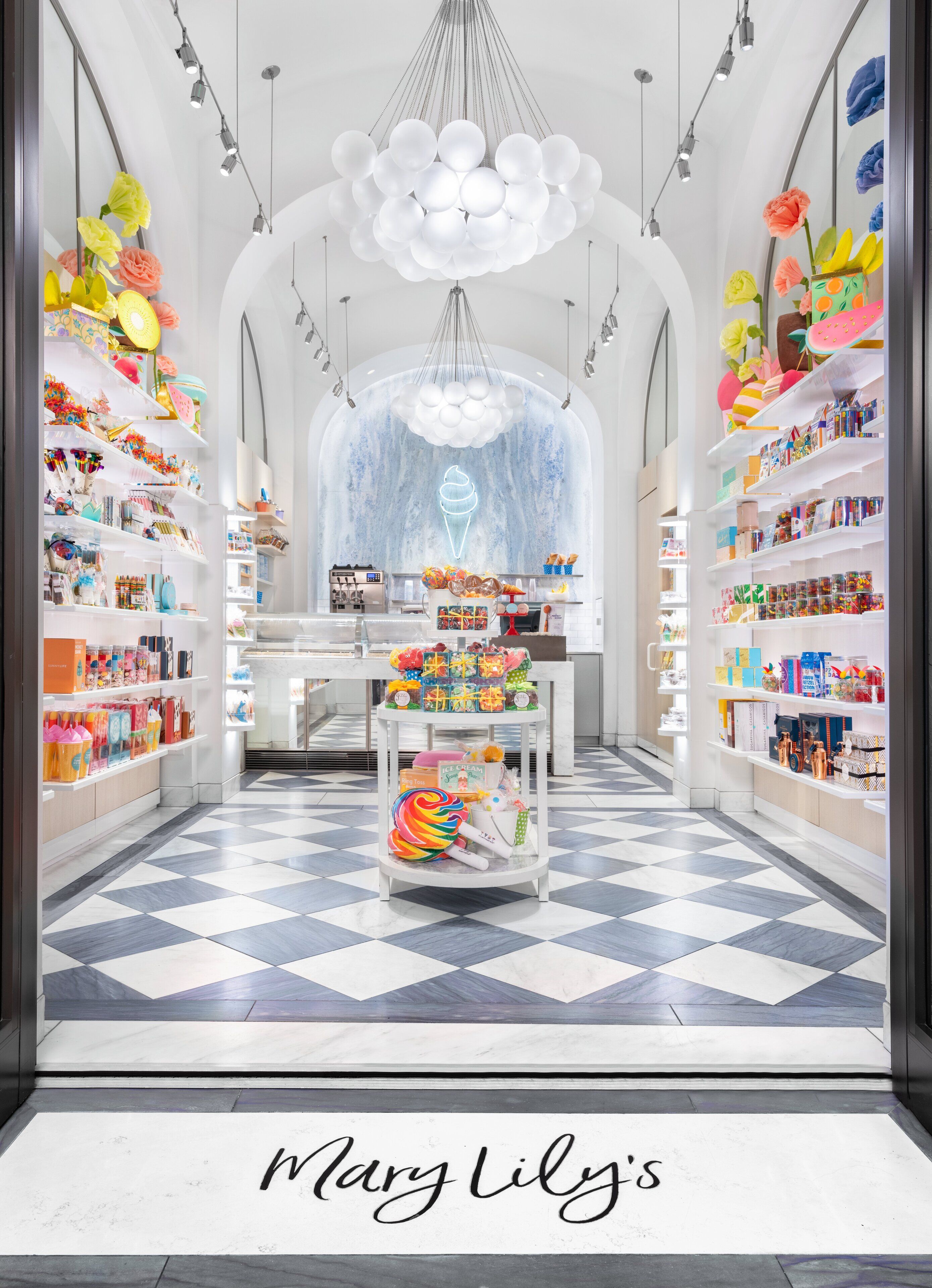 A brightly lit store with a checkered floor and shelves stocked with colorful items.