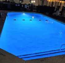 Una piscina al aire libre de temporada, sillones reclinables de piscina