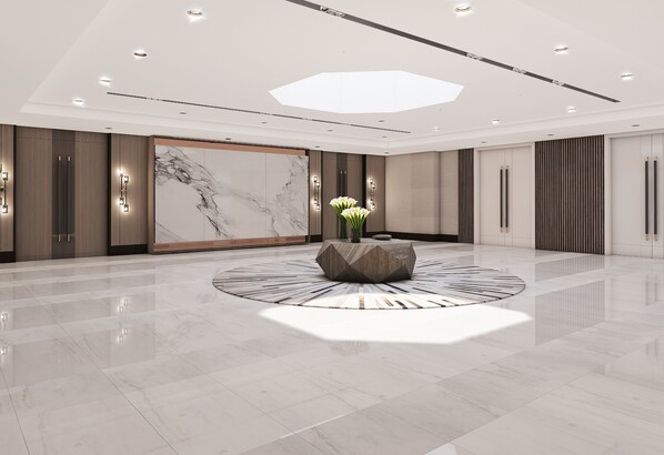 A spacious lobby with a marble floor, a central decorative column, and recessed lighting. - DoubleTree by Hilton Hotel Miami Airport & Convention Center (Miami)