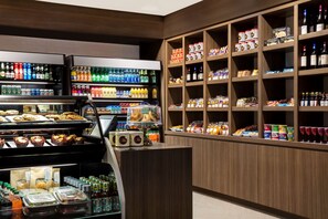 A well-stocked convenience store with shelves of beverages, snacks, and packaged goods. - DoubleTree by Hilton Hotel Miami Airport & Convention Center (Miami)