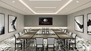 A conference room with a long table, white chairs, and a 'DoubleTree by Hilton' sign. - DoubleTree by Hilton Hotel Miami Airport & Convention Center (Miami)