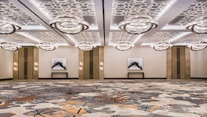 A spacious lobby with a patterned floor, modern chandeliers, and a geometric ceiling design. - DoubleTree by Hilton Hotel Miami Airport & Convention Center (Miami)