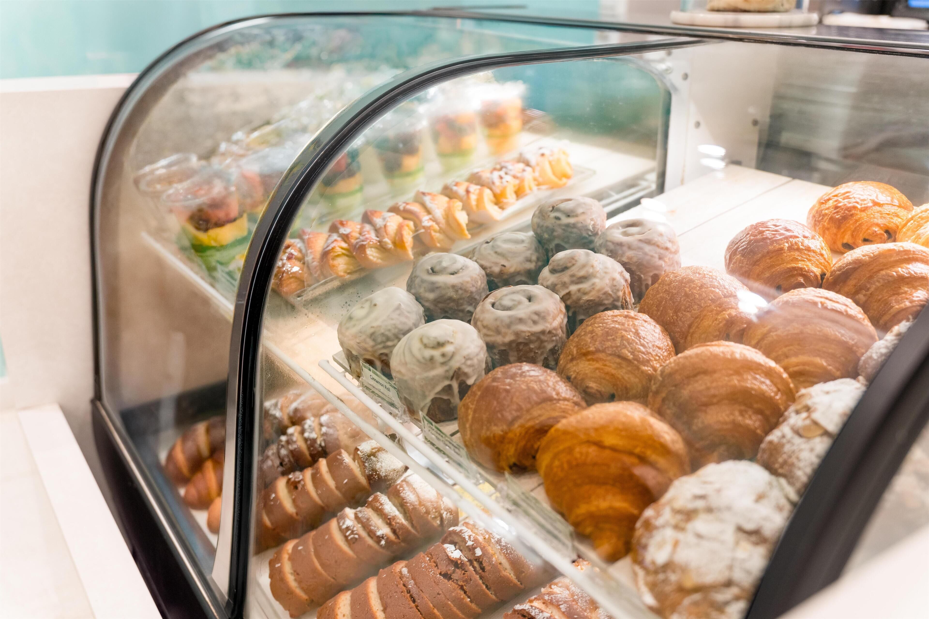 A bakery display case with various pastries.