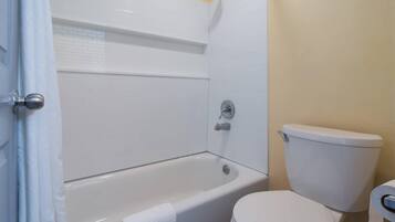 Un baño con bañera, inodoro y ducha.