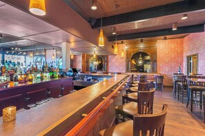 Enjoy a drink at the bar, where a long counter and stools await.