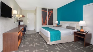 A hotel room with a bed, bedside tables, a desk, a television, and a door. - Howard Johnson by Wyndham Athens (Athens)