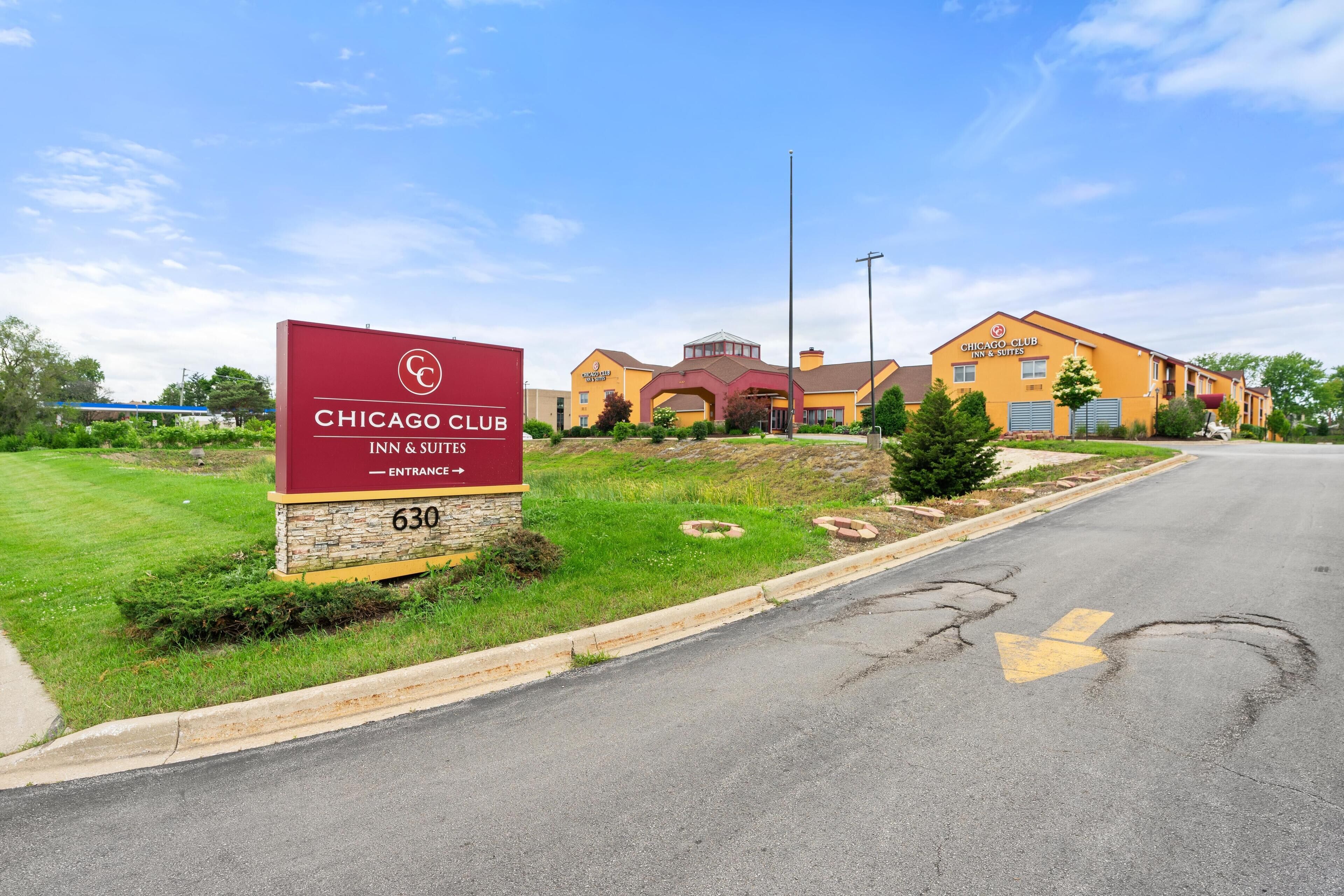 A hotel sign with the name "Chicago Club Inn & Suites" and the address "630".