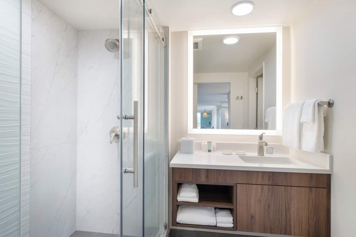 combined shower/bathtub, designer toiletries, hair dryer, bathrobes