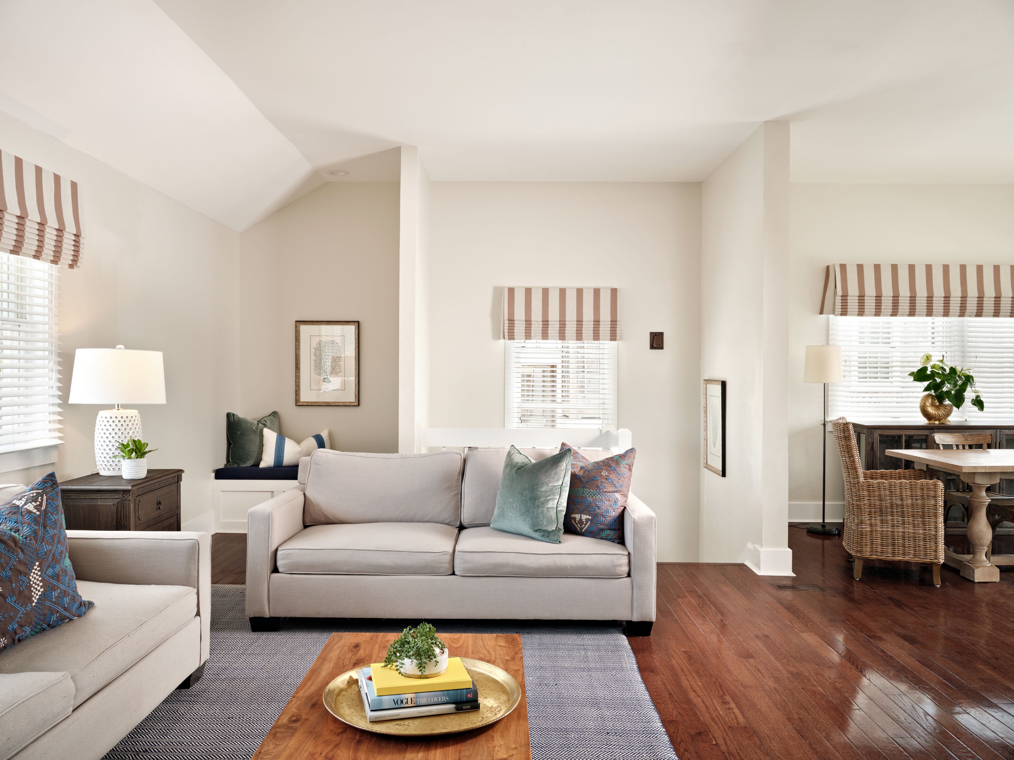 A living room with a sofa, coffee table, and dining area.
