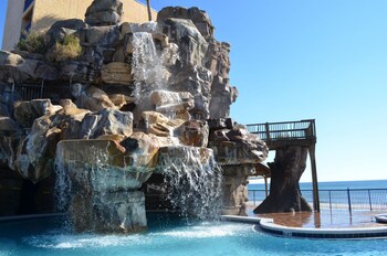 Outdoor pool, open 8:00 AM to 10:00 PM, sun loungers at Days Inn by Wyndham Panama City Beach/Ocean Front