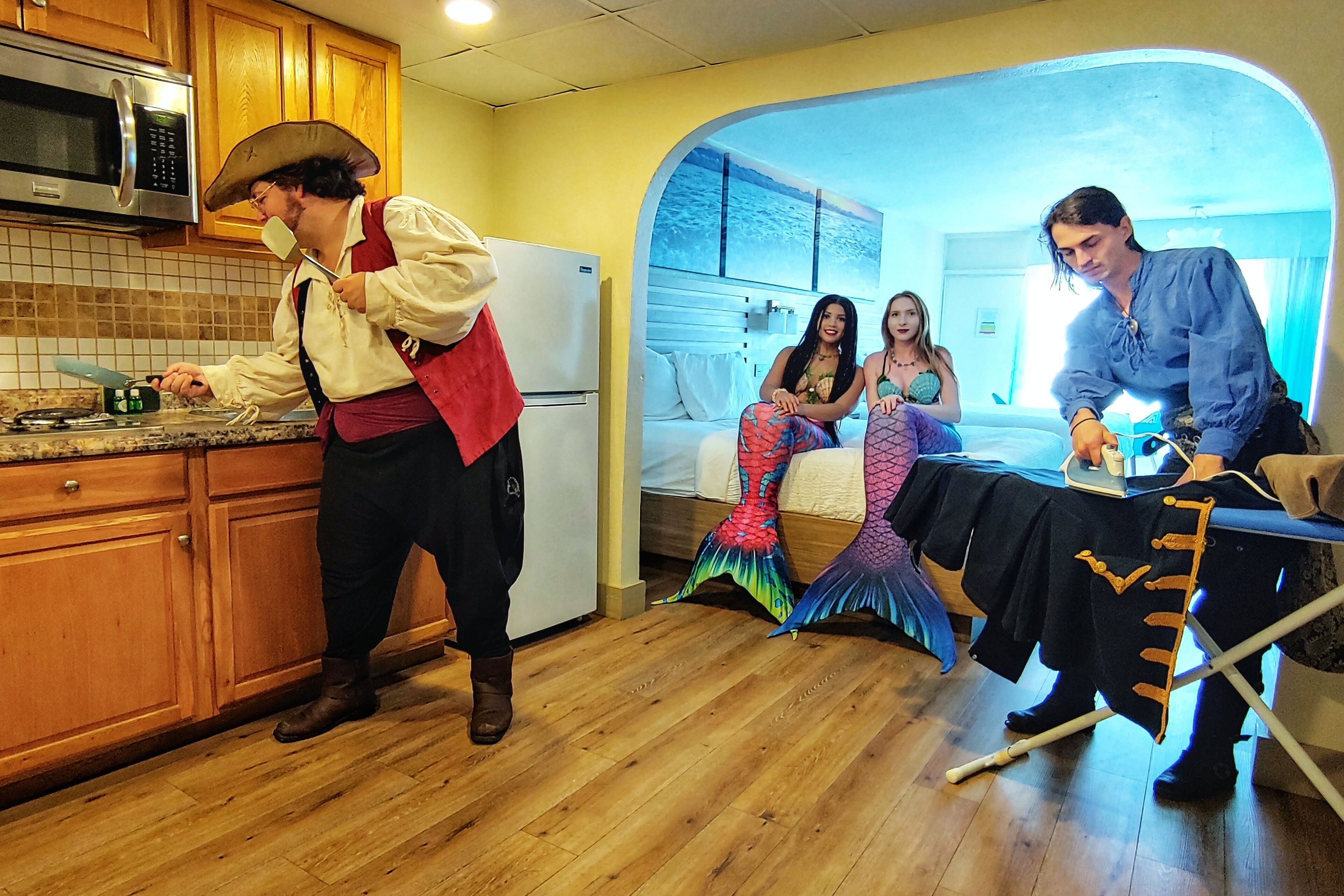 A kitchen with wooden cabinets, a microwave, and a refrigerator.