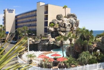 Outdoor pool, open 8:00 AM to 10:00 PM, sun loungers at Days Inn by Wyndham Panama City Beach/Ocean Front