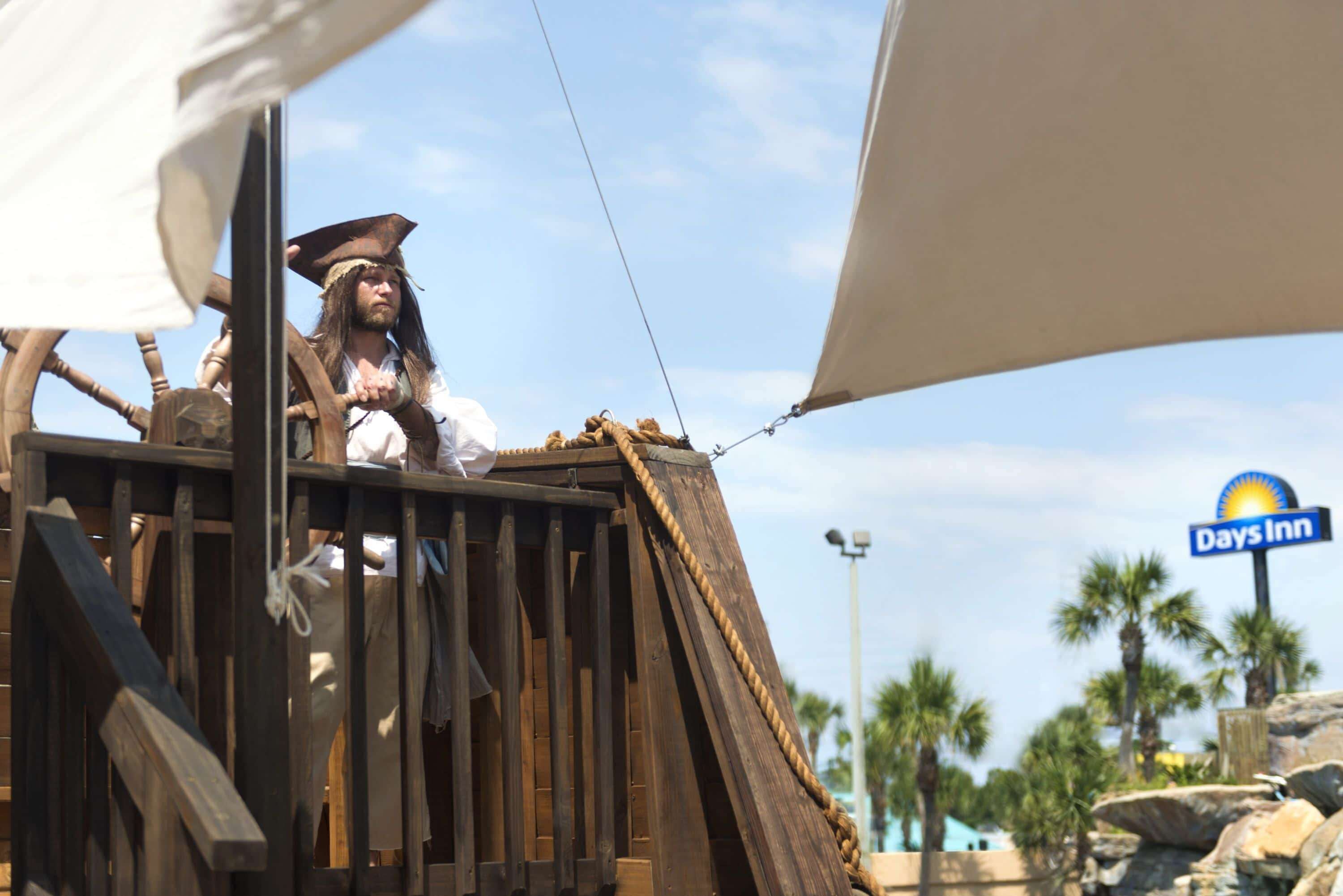 A wooden structure with a rope and a sign for Days Inn in the background.